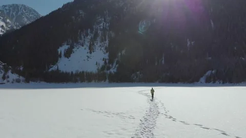 Man athlete workouts in the winter in the mountains Stock Footage 143922257