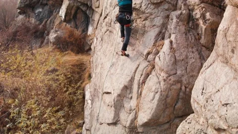 Man athlette climbing on the high rock Stock Footage 164537191