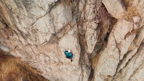 Man athlette climbing on the high rock Stock Footage 164538428