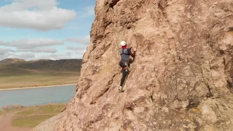 Man athlette climbing on the high rock Stock Footage 174096875