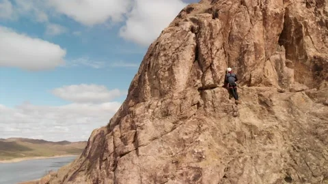 Man athlette climbing on the high rock Stock Footage 174099243