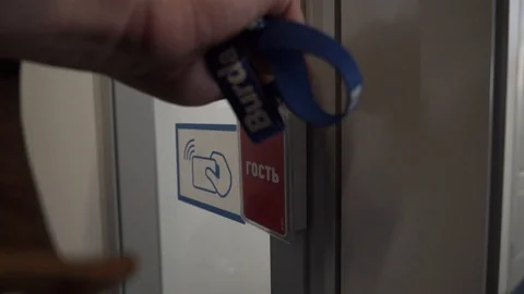 Man attach his plastic key card in elevator in order to unlock ability to enter Stock Footage 108555681