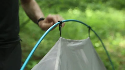 A man attaches a tent to a frame Video stock 312162611