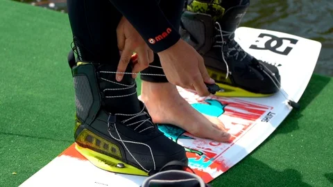  A man attaches a wakeboard Stock Footage 107537493