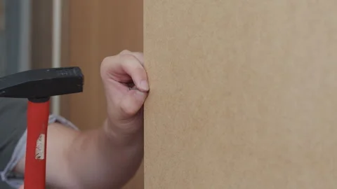 Man Attaching Back Panel To New Wardrobe Stockbeeldmateriaal 338375271