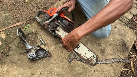 Man attaching chainsaw bar after repair Stock Footage 326284944