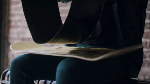 Man Attaching Grip Tape to Deck Stock Footage 133622525