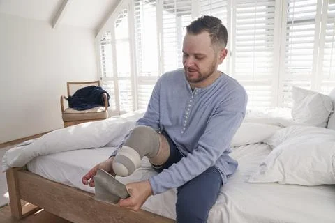 Man attaching leg prosthesis Stock Photos