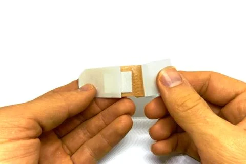 Man attaching a plaster Stock Photos