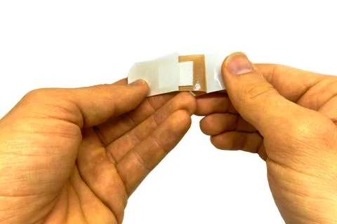 Man attaching a plaster Stock-Fotos