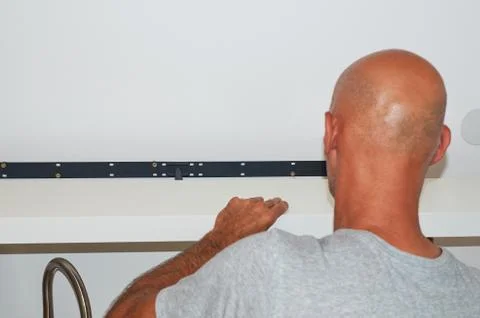 Man attaching a shelf Stock Photos