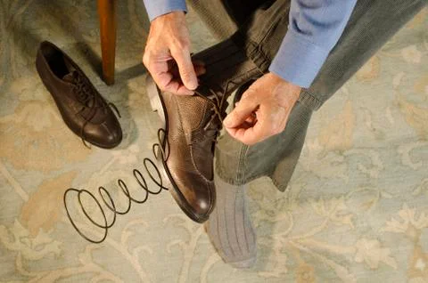 Man attaching spring to shoe Stock Photos