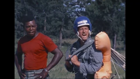 Man attaching strap to Astronaut Pete Conrad parachute - 1968 Stockbeeldmateriaal 104331065