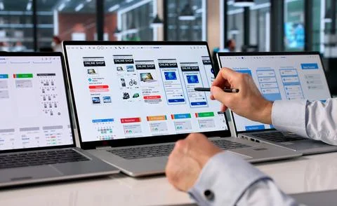 Man Attentively Designing User-friendly App Interface On Laptop At Work. Stock Photos