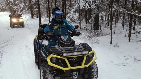 A man on an ATV ride through a winter forest in winter 스톡 동영상 161178200