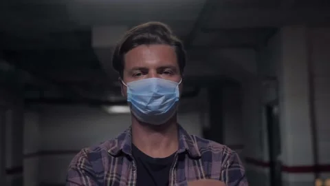 Man auto mechanic wearing protective face mask while standing with arms crossed Stock Footage 143648030