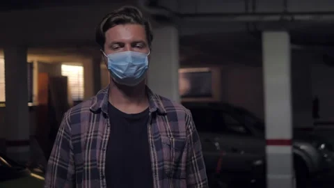 Man auto mechanic wearing protective face mask while standing with arms crossed Stock Footage 147863690