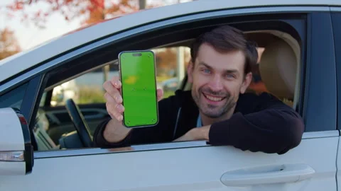 Man in auto shows car sharing app on smartphone from window Stock Footage 300589074