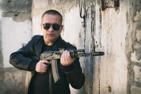 Man with a automatic rifle outdoors Stock Photos