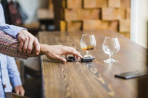 Man avoiding her friend taking car keys table Stock Photos