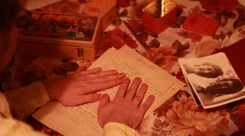 Man awakens memories reading old letters and looking at old photos Stock Footage 59372343