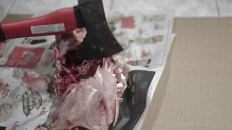 A man with an ax cut the chicken into thick paper from the shop Stock Footage 56219257