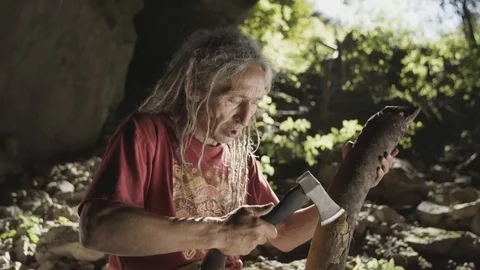 Man with an axe cutting and shaping a piece wood Stock Footage 91960960