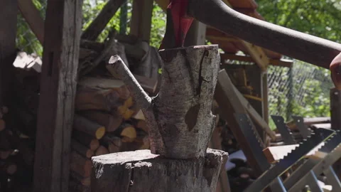 Man with axe fails to split wood with an axe three times in slow motion Stock Footage 131054029