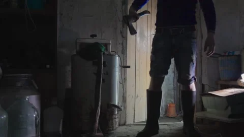 A man with an axe standing in a dark room. copy space Video stock 137970111