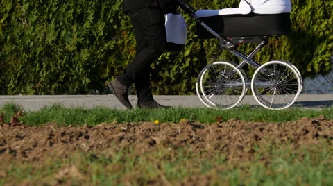 Man with baby stroller Stock Footage 48829550