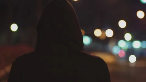 Man with Back Against Camera with Black Hood in a Deserted Neighborhood 库存影片 150087982