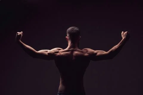 Man from back on black background Stock Photos