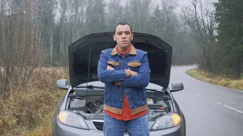Man at the background of broken car. Stressed male driver  Stock Footage 142830297