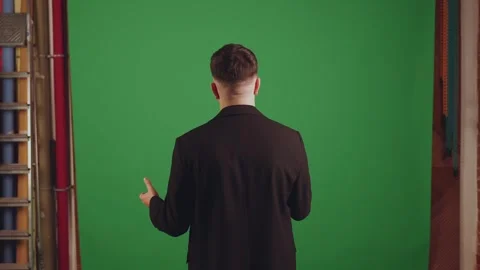 A man on a background of chromakey talks standing with his back Stock Footage 269147471