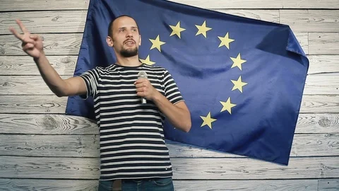 A man on the background of the EU flag says it Stock Footage 95180720