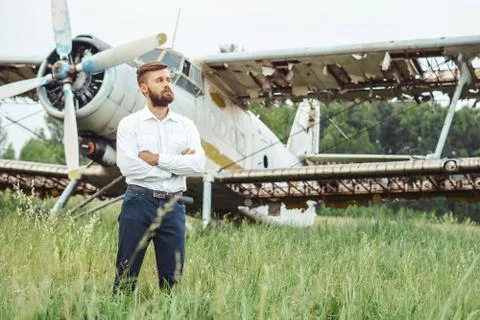 A man on the background of an old plane Photos