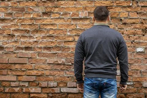 Man on the background of a red brick wall. Stock Photos