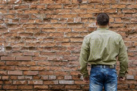 Man on the background of a red brick wall. Stock Photos