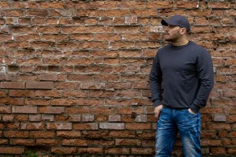 Man on the background of a red brick wall. Stock Photos