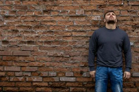 Man on the background of a red brick wall. Stock Photos