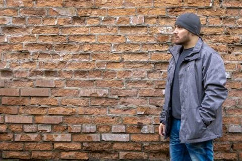 Man on the background of a red brick wall. Stock Photos