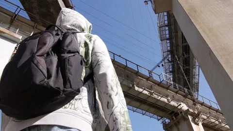 Man with a backpack against the background of three Viaducts. Video stock 142370997