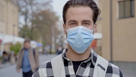 Man with backpack and protective face mask standing at the street. Stock Footage 164145667