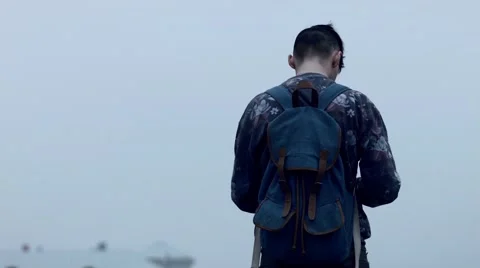 A man with a backpack in the city Stock Footage 62759169