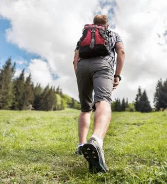 Man with backpack climb up to the  hill Stock Photos