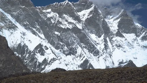 Man with backpack climb the mountain slope in the Himalayas Stock Footage 87933392