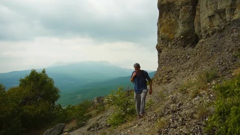 Man With Backpack Climbing Mountain Path In Summer Stock Footage 115150553