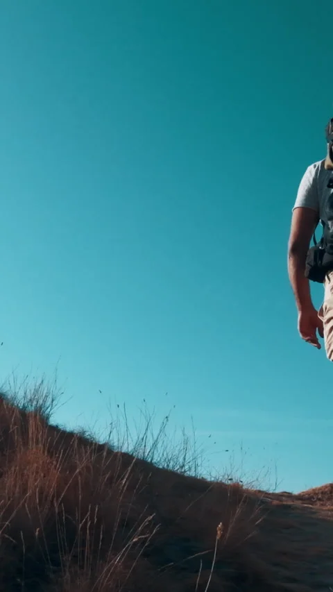 The man with backpack is climbing the mountain. slow motion Stock Footage 242128197