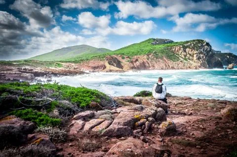 Man, backpack, coast, excursion, alghero, sardinia Stock Photos