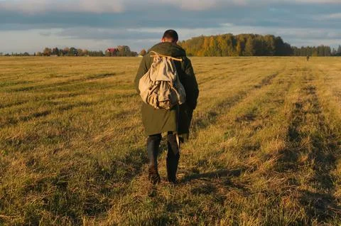 A man with a backpack in the field Stock Photos